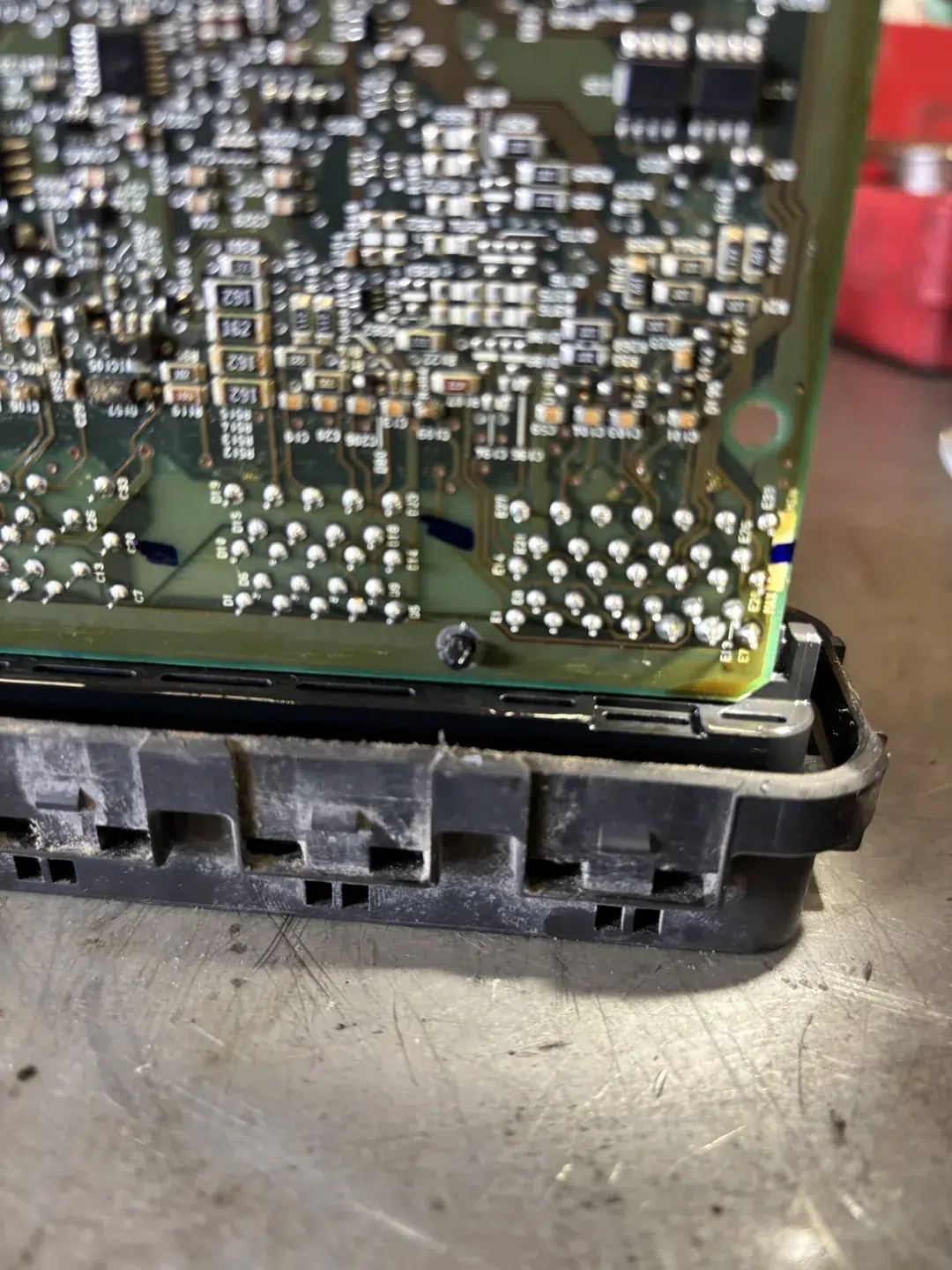 Opened Mitsubishi Eclipse PCM showing the circuit board above its black casing
