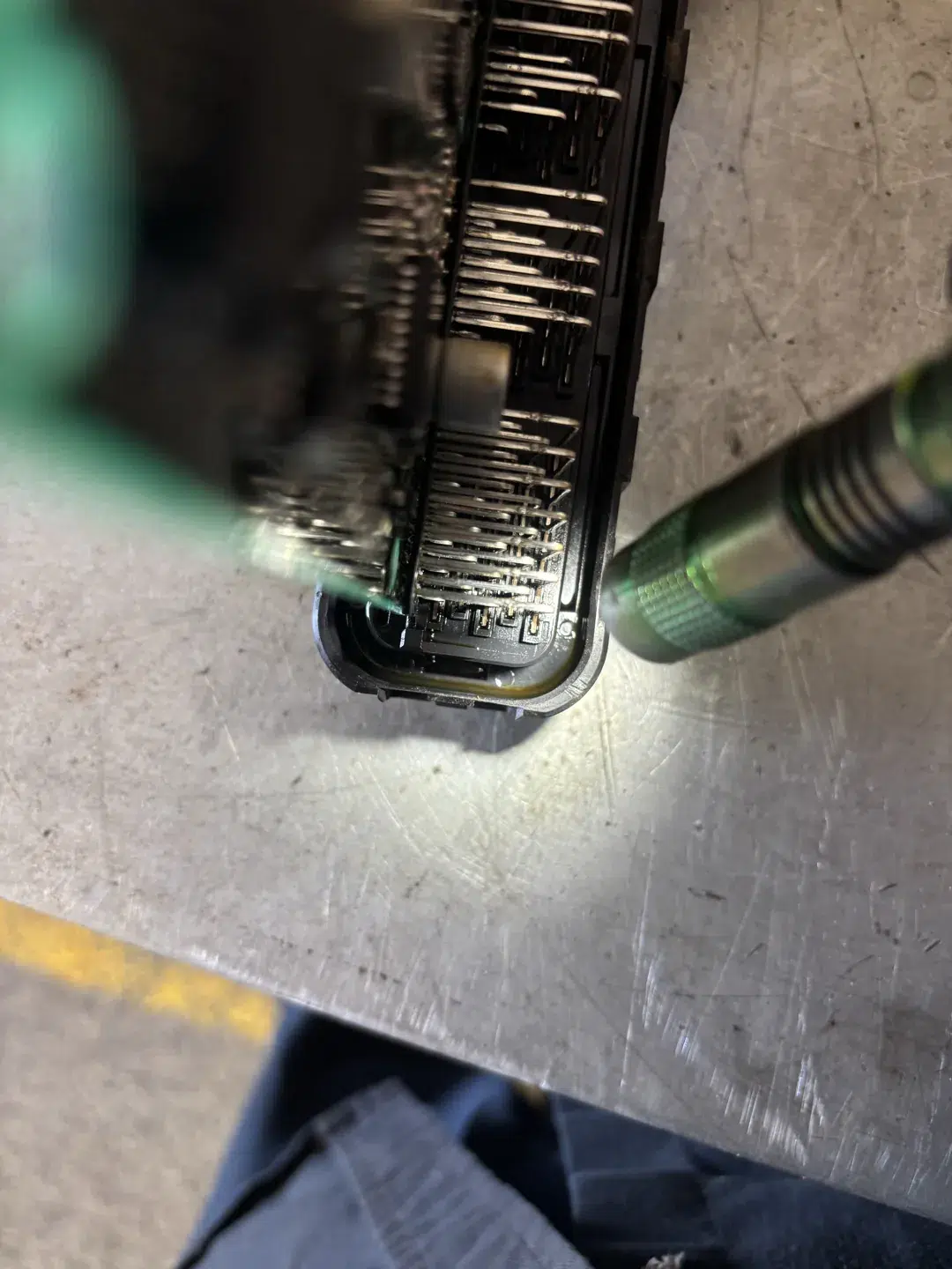 Close view of the Eclipse PCM connector pins and oil inside the casing