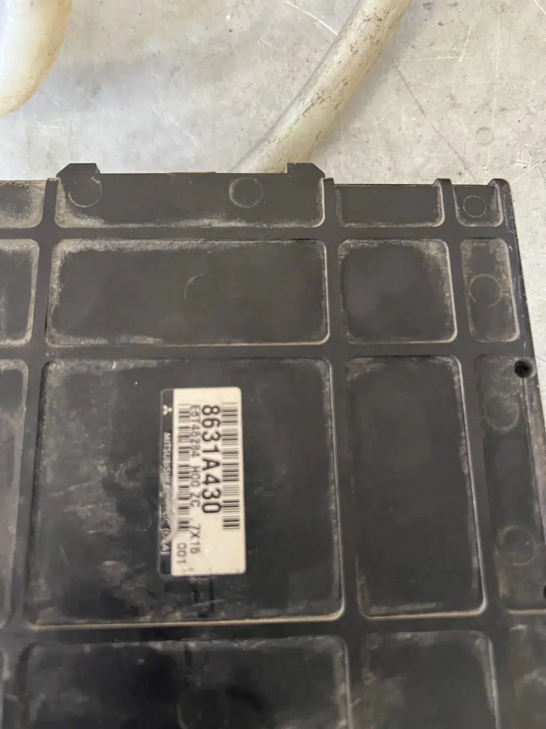 Exterior of the Mitsubishi Eclipse PCM with its identification label